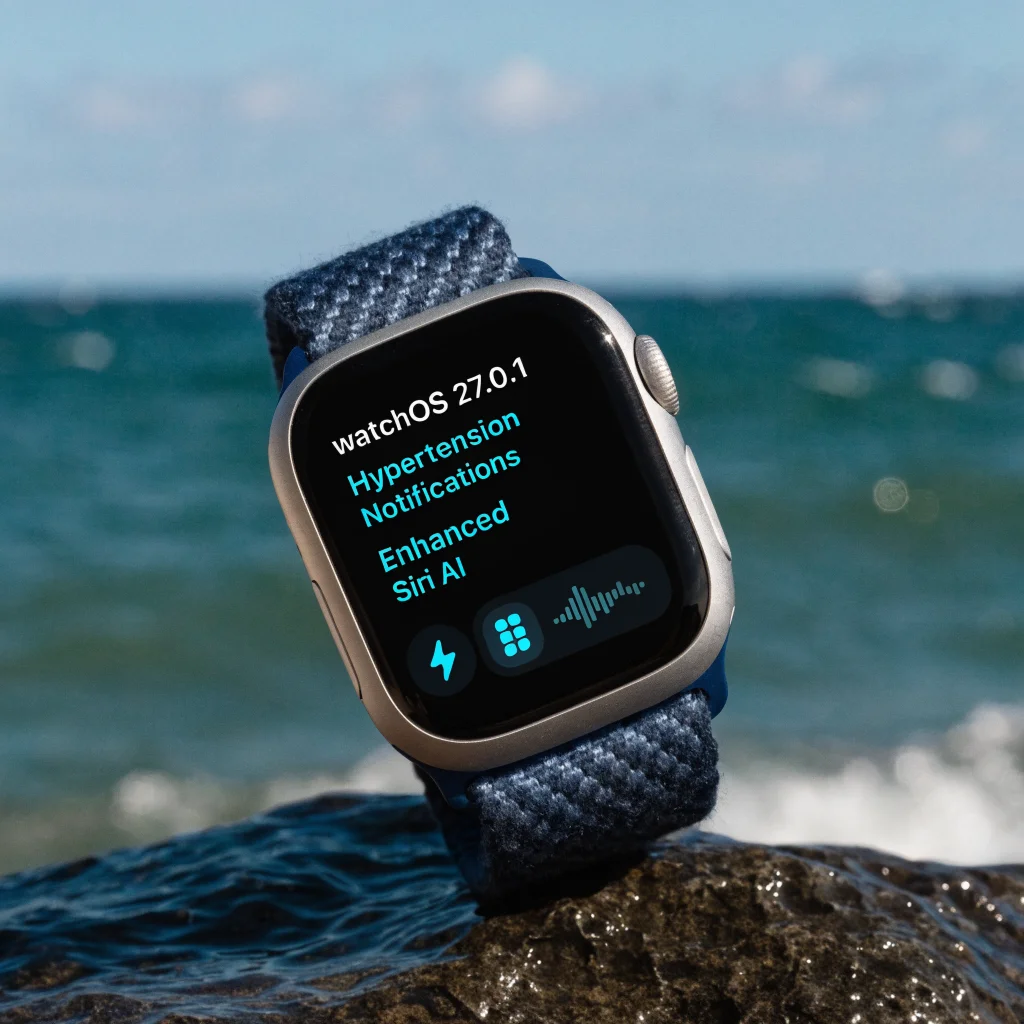 A close-up photo of an Apple Watch Series 12 displaying updated watchOS 27.0.1 with enhanced hypertension notifications and Siri AI features on the screen.