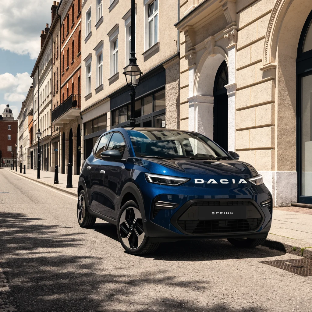 A realistic photo of a Dacia Spring electric car on a European city street showcasing its compact design and branded details.