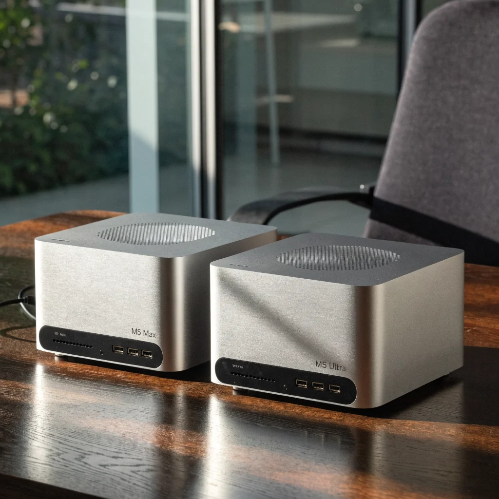 Close-up photo of Apple Mac Studio M5 Max and M5 Ultra side by side showcasing Thunderbolt 5 ports and sleek design on a modern desk.