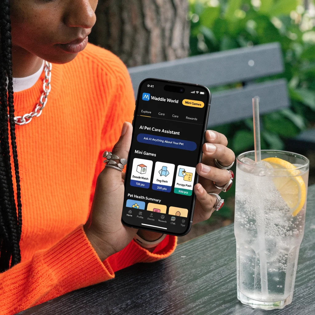 A realistic photo of a person interacting with a smartphone displaying a Meta Waddle World AI pet care app featuring mini-games.