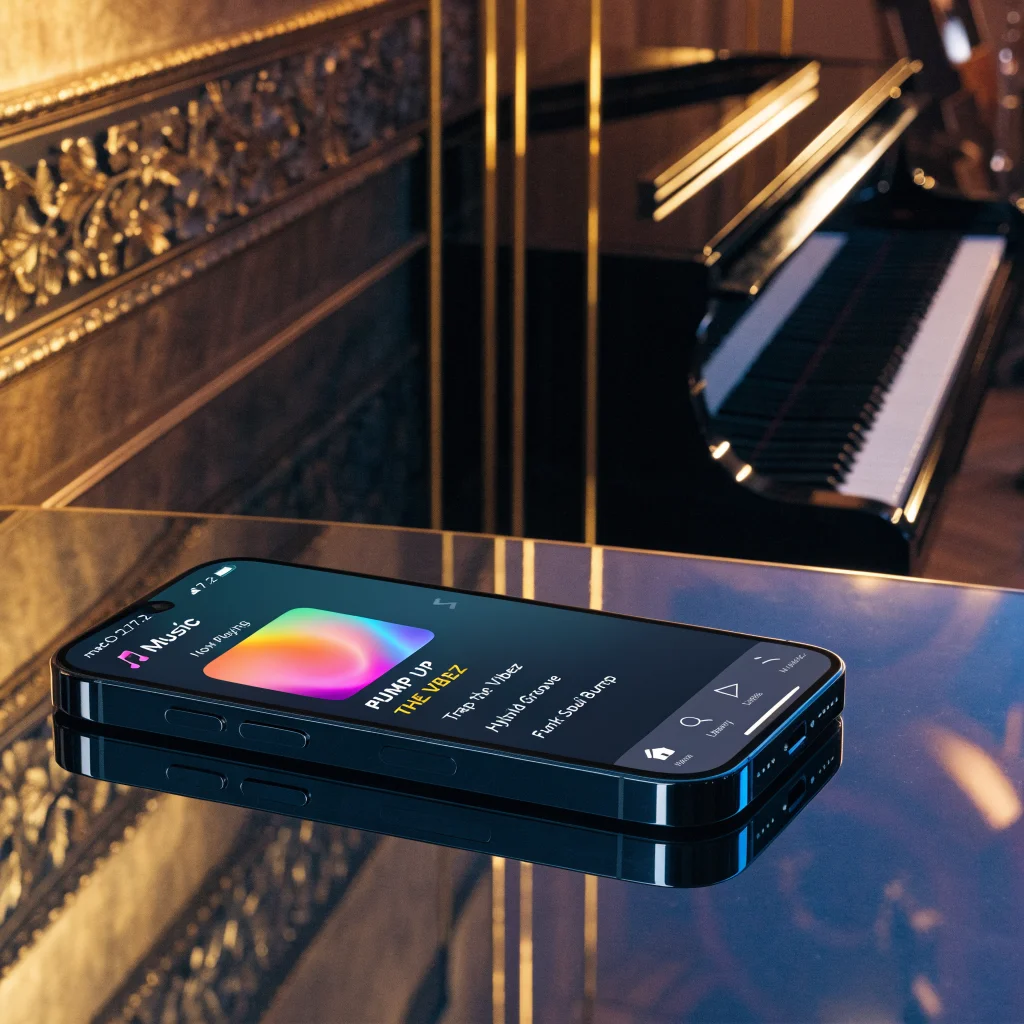 A close-up photo of an iPhone displaying the new Apple Music logo and interface on macOS 27.2 beta in a modern music hall setting.