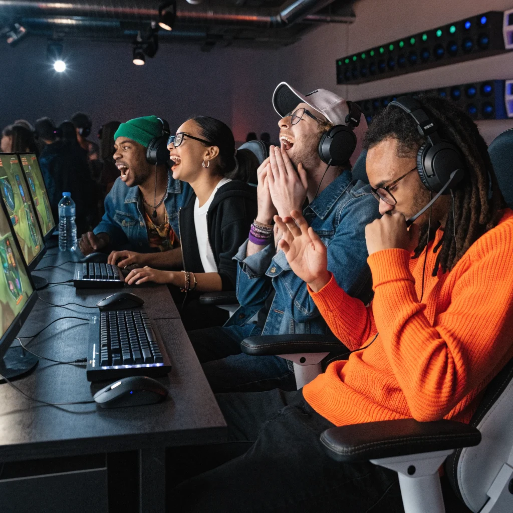 A group of gamers enthusiastically playing League of Legends Classic on old Summoner's Rift, celebrating nostalgic esports moments.