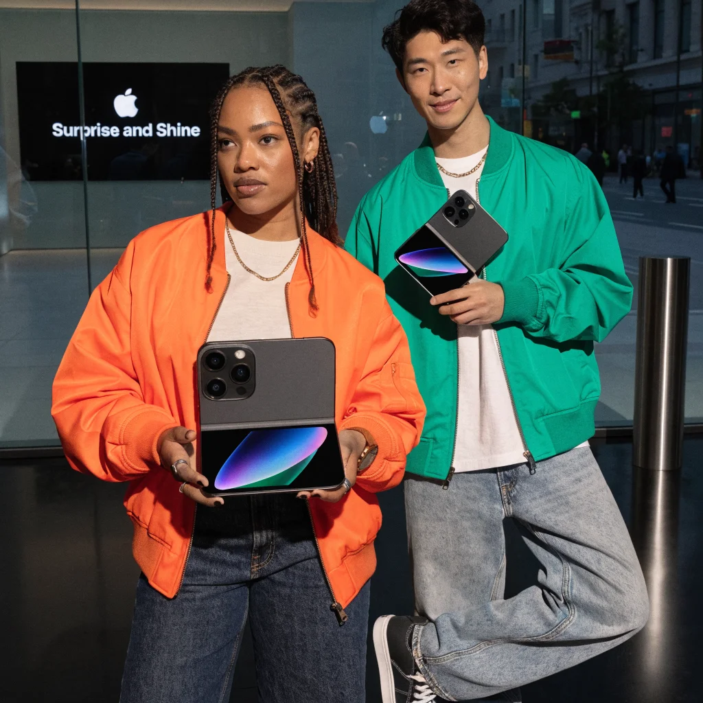 A realistic photo of the new foldable iPhone Duo showcasing its 48-megapixel dual cameras, displayed at the Apple “Surprise and Shine” event.